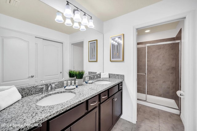 bathroom with tile patterned floors, vanity, and an enclosed shower