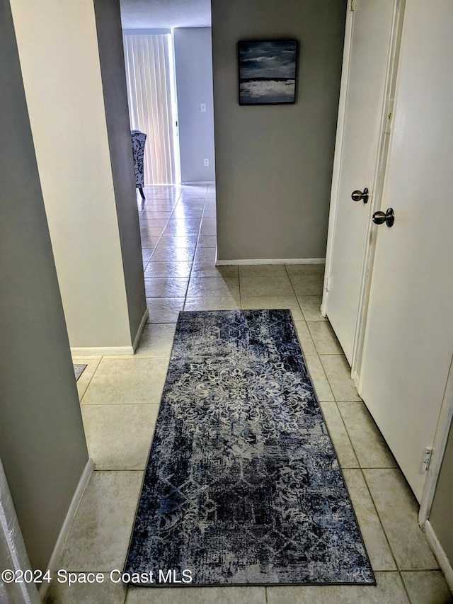 corridor with light tile patterned floors