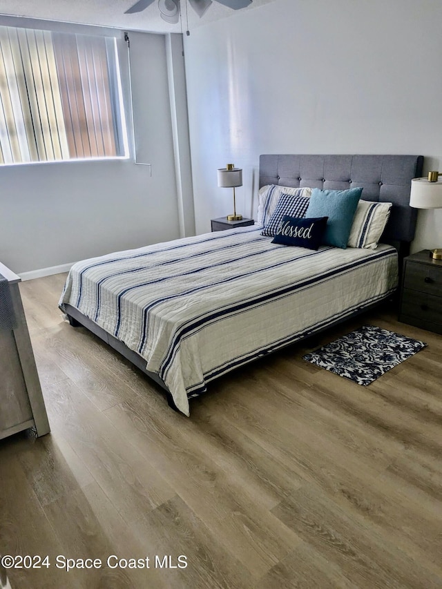 bedroom with hardwood / wood-style flooring and ceiling fan