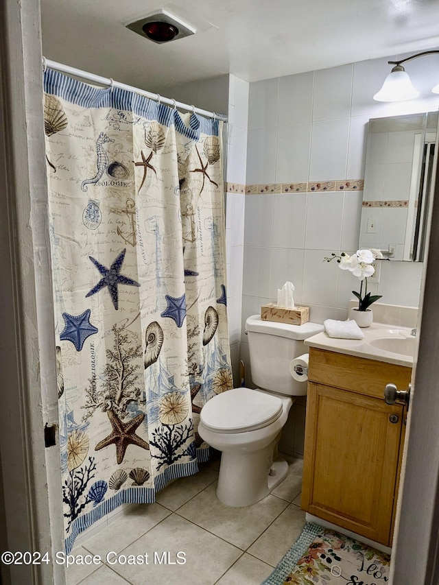 bathroom featuring walk in shower, tile patterned flooring, vanity, and toilet