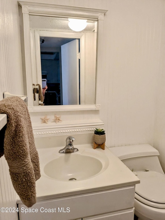 bathroom featuring radiator, vanity, and toilet