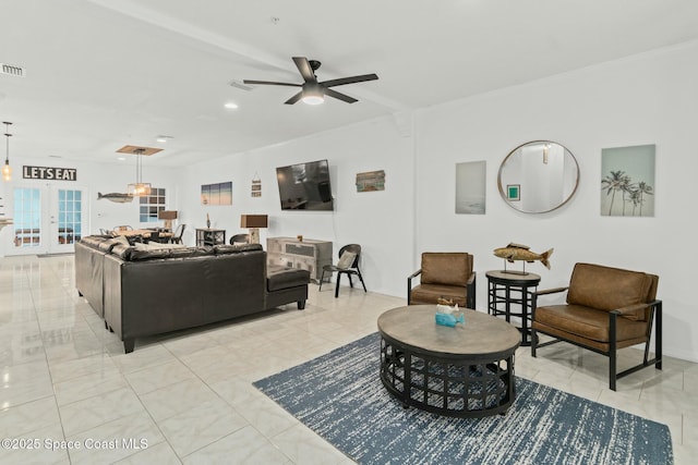 living room featuring ceiling fan and french doors