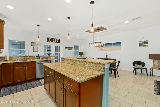 kitchen with pendant lighting, dishwasher, a center island, french doors, and sink