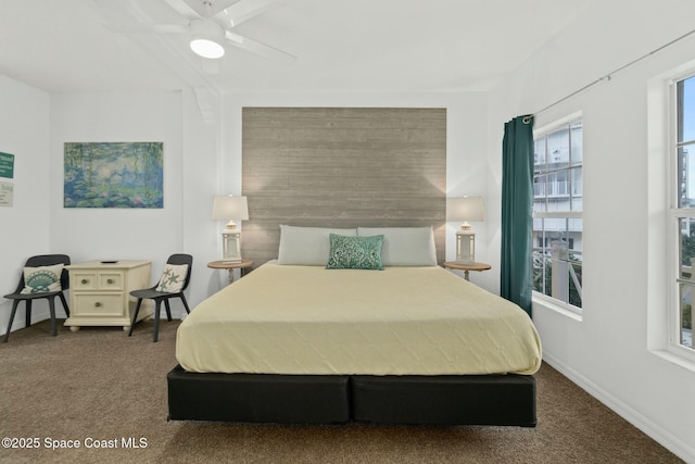 bedroom with dark colored carpet and ceiling fan