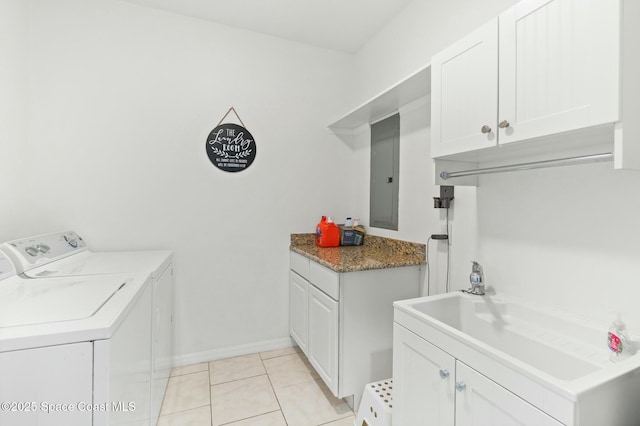 laundry area with cabinets, sink, light tile patterned floors, washing machine and clothes dryer, and electric panel