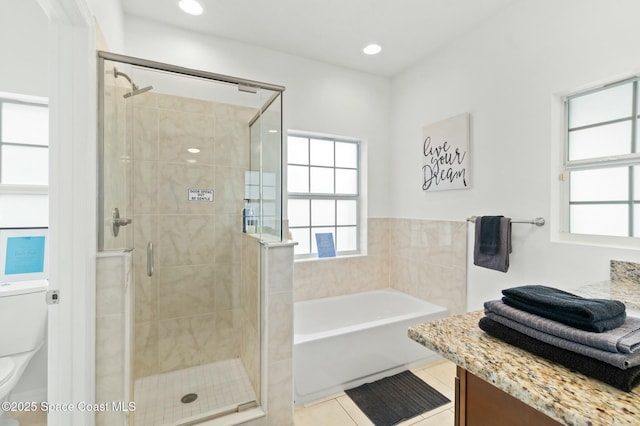 full bathroom featuring tile patterned floors, vanity, toilet, and shower with separate bathtub