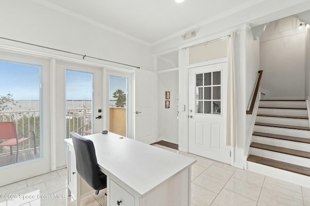 office space with a wealth of natural light, crown molding, and light tile patterned flooring