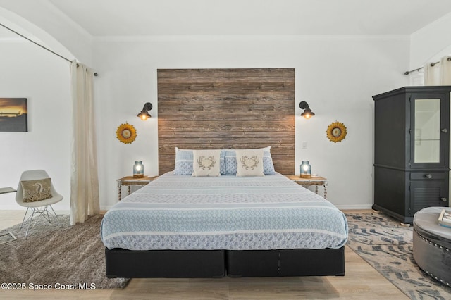 bedroom featuring crown molding and hardwood / wood-style floors