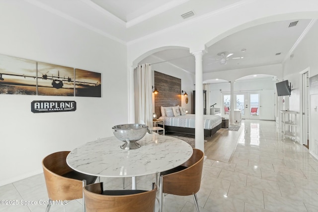 dining room with ceiling fan, ornamental molding, french doors, and decorative columns