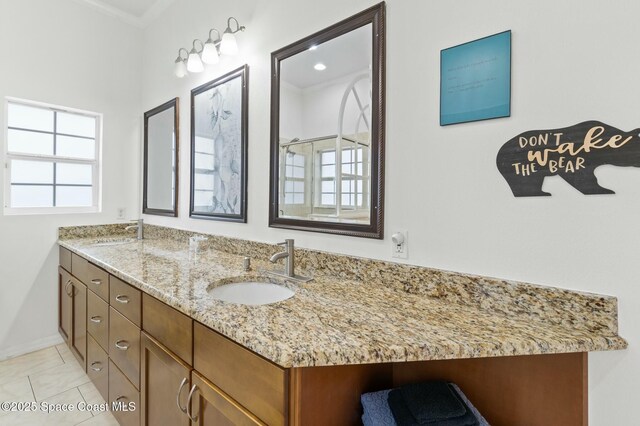 bathroom featuring tile patterned flooring, vanity, ornamental molding, and walk in shower