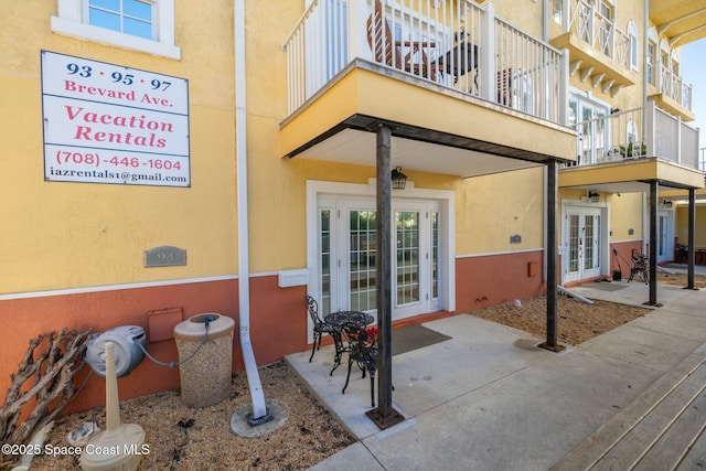 entrance to property featuring french doors and a balcony