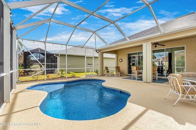 view of swimming pool featuring a patio area and glass enclosure