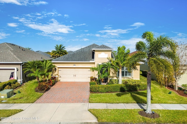 view of front of house with a garage and a front yard