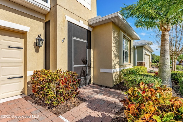 view of exterior entry featuring a garage