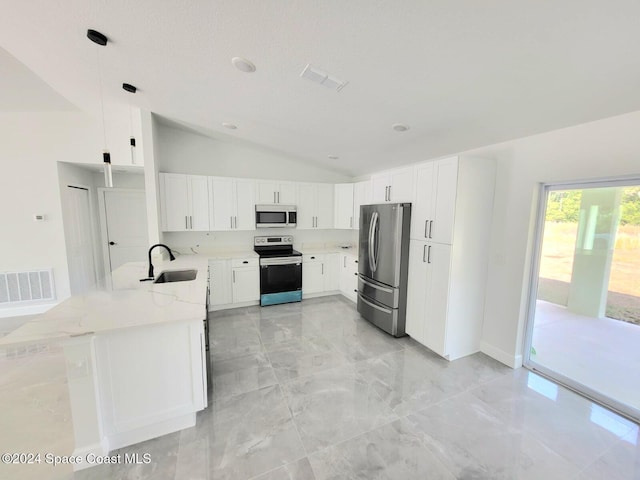 kitchen with light stone countertops, kitchen peninsula, stainless steel appliances, pendant lighting, and white cabinetry