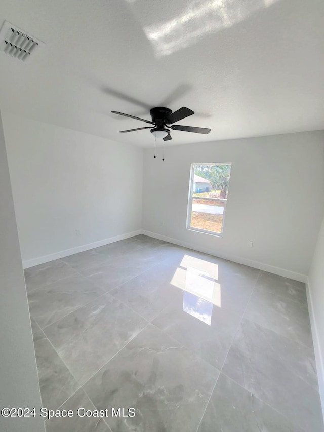 spare room with ceiling fan