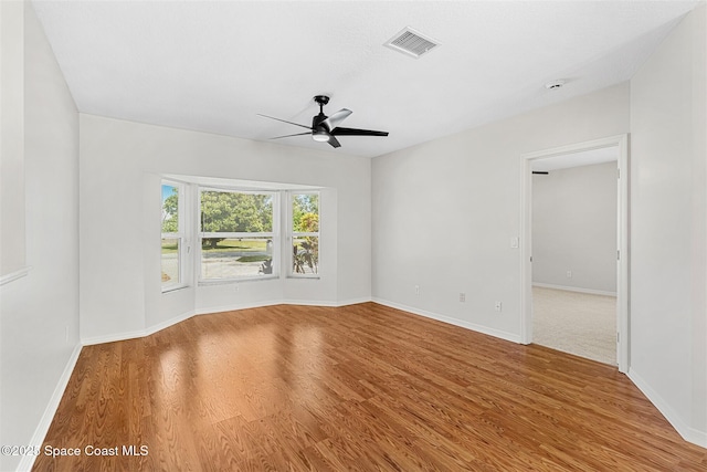 empty room featuring ceiling fan and hardwood / wood-style floors