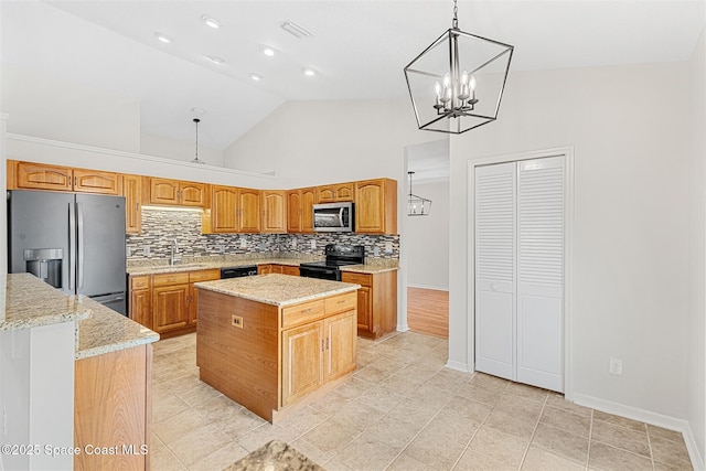 kitchen with sink, decorative light fixtures, high vaulted ceiling, a kitchen island, and black appliances