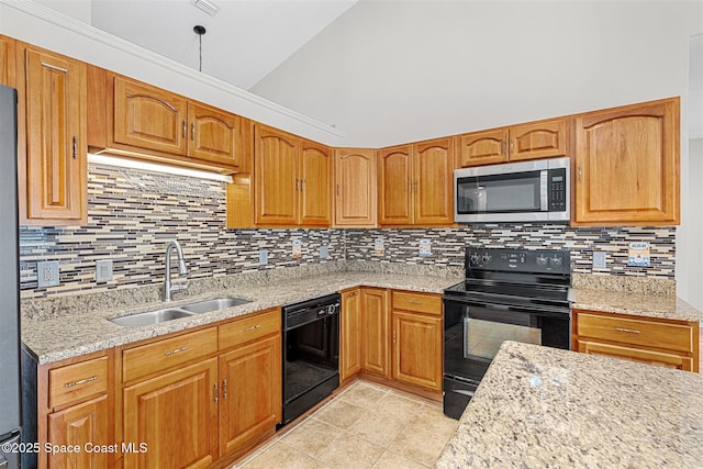 kitchen featuring sink, decorative backsplash, black appliances, and light stone counters