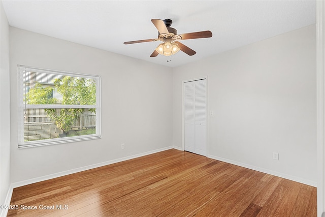 spare room with ceiling fan and hardwood / wood-style floors