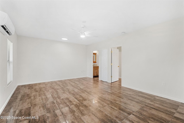 unfurnished room with ceiling fan and a wall unit AC