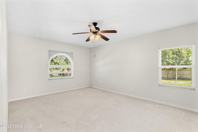 carpeted spare room with ceiling fan