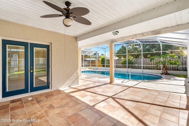 view of swimming pool with ceiling fan, french doors, and a patio area