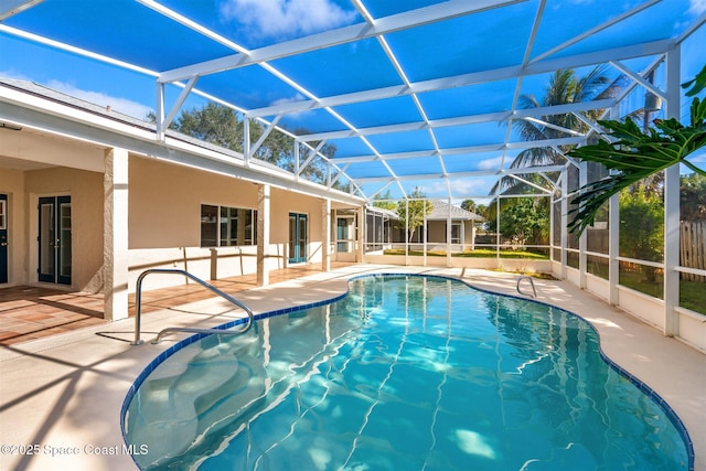 view of swimming pool with a lanai and a patio