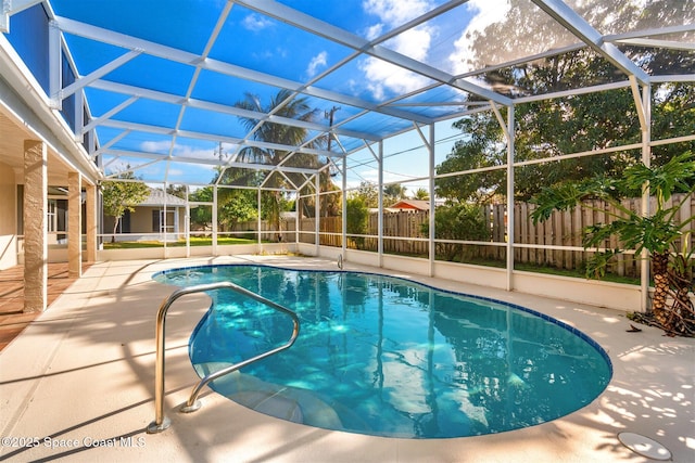 view of pool featuring a patio area and glass enclosure