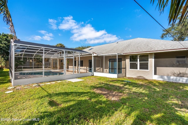 back of property featuring a lawn