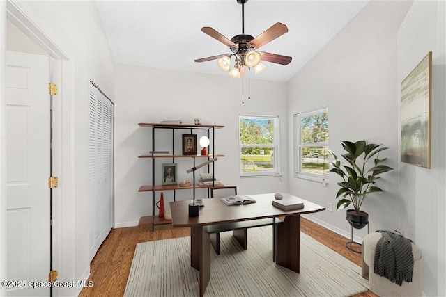 office area featuring lofted ceiling, ceiling fan, and wood-type flooring