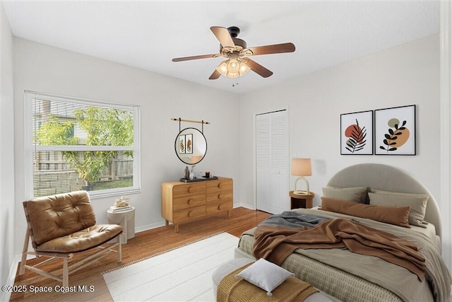 bedroom featuring a closet, ceiling fan, and light hardwood / wood-style floors