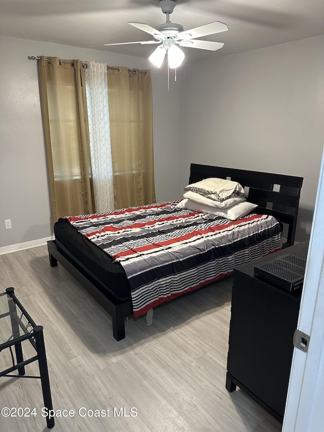 bedroom featuring hardwood / wood-style flooring and ceiling fan