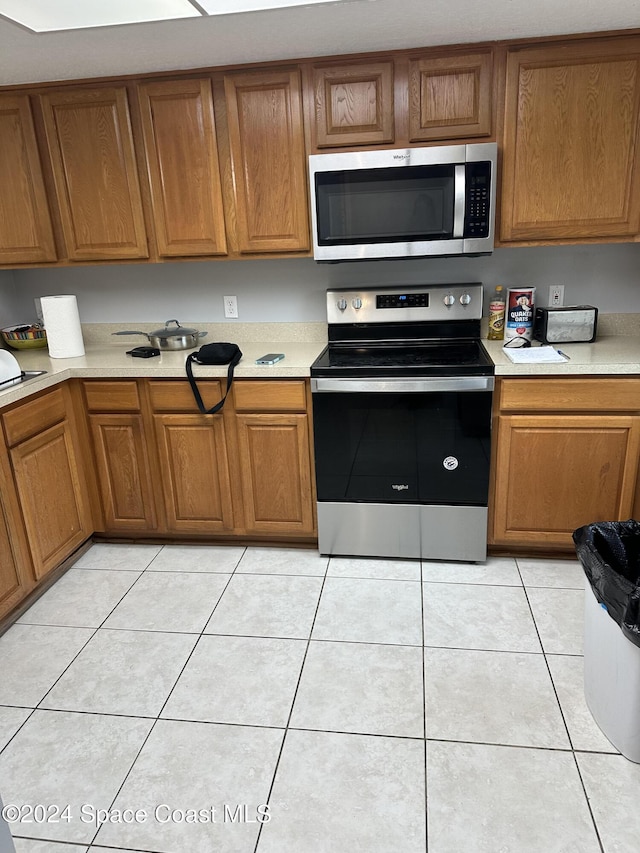 kitchen with appliances with stainless steel finishes and light tile patterned floors