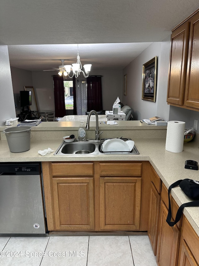 kitchen featuring dishwasher, sink, hanging light fixtures, light tile patterned floors, and ceiling fan with notable chandelier