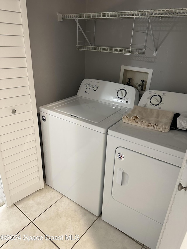 laundry area featuring light tile patterned flooring and independent washer and dryer