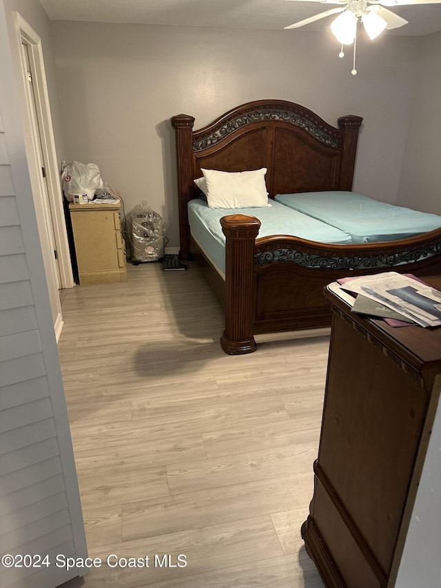 bedroom with light hardwood / wood-style flooring and ceiling fan