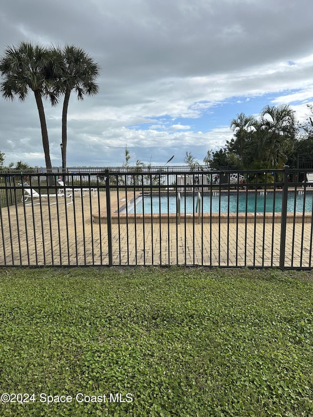 view of swimming pool featuring a water view