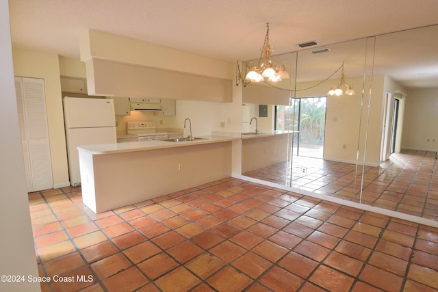 kitchen with white appliances, an inviting chandelier, tile patterned floors, and sink