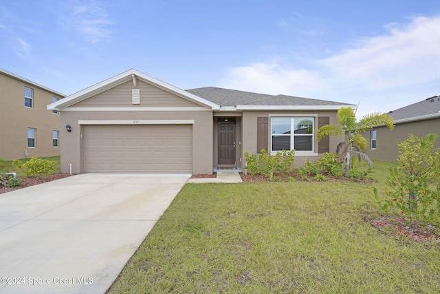 view of front of house with a front yard and a garage