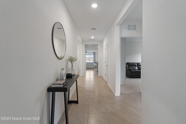 hall featuring light tile patterned floors