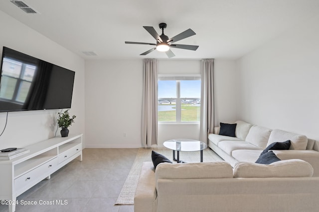 tiled living room with ceiling fan