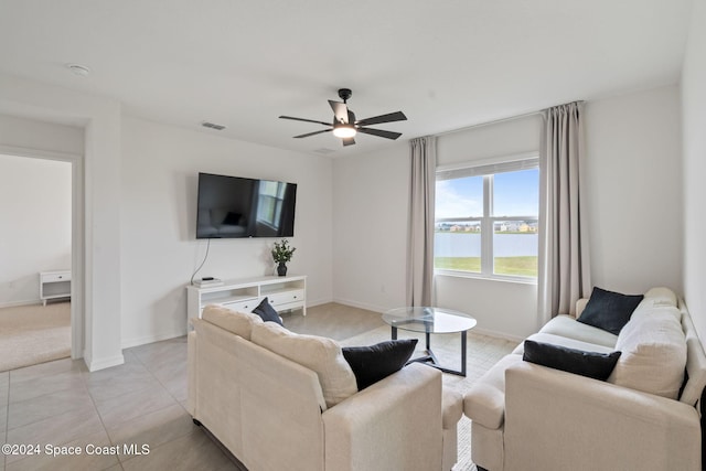 living room featuring ceiling fan and light tile patterned flooring