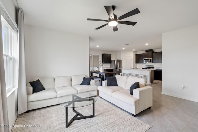 living room with ceiling fan and light tile patterned flooring