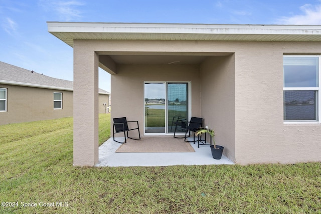 rear view of house with a yard and a patio