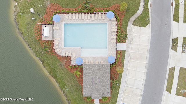 birds eye view of property with a water view