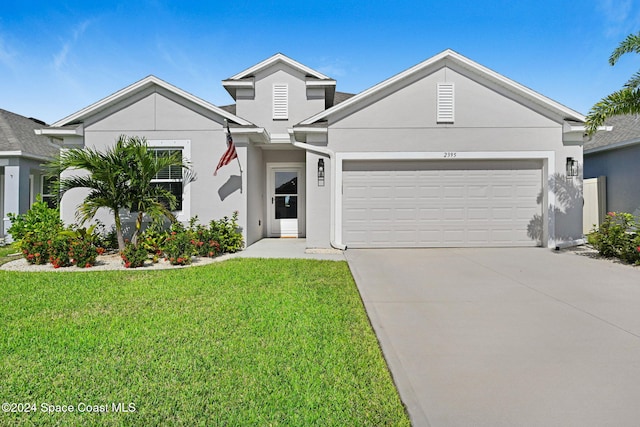 view of front of house featuring a garage and a front lawn