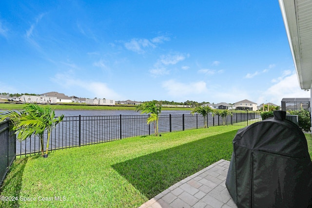 view of yard featuring a patio and a water view