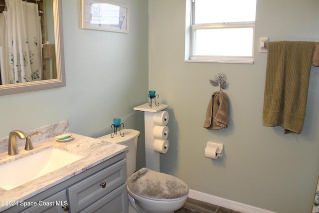 bathroom with tile patterned floors, curtained shower, vanity, and toilet