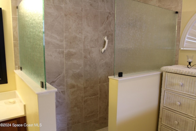 bathroom featuring vanity and a tile shower